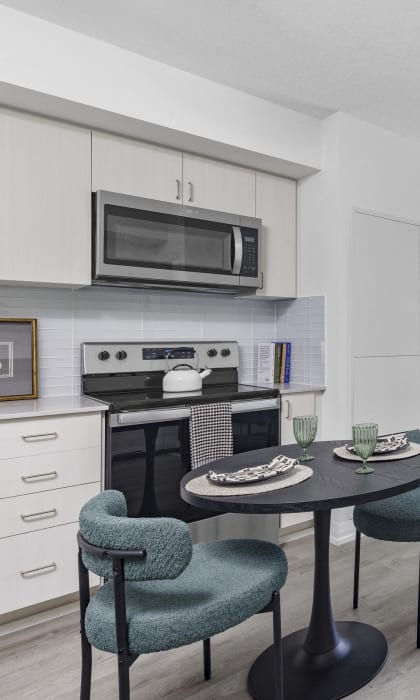 an apartment with a kitchen and a living room with a table and chairs
