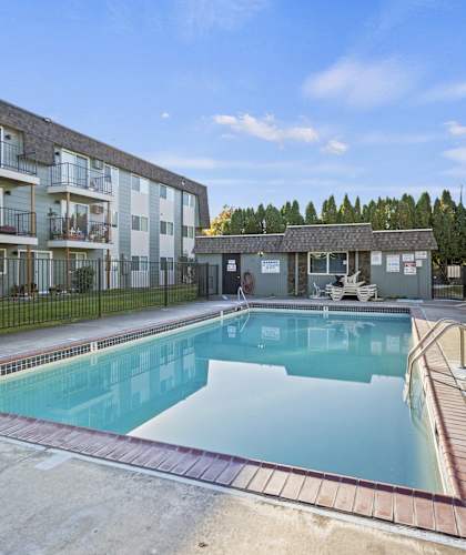 a swimming pool in front of an apartment building