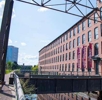 a large brick building with a bridge in front of it