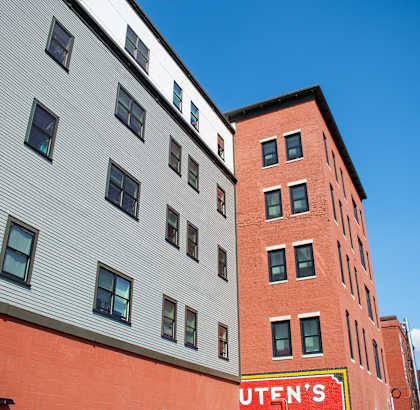 a red brick building with a white building next to it