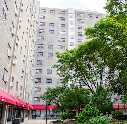 a large white building with a red awning in front of it