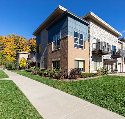 A modern two-story building with a balcony on the upper floor.