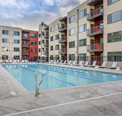 an apartment swimming pool in front of an apartment building at The Zeller, Salt Lake City, 84115