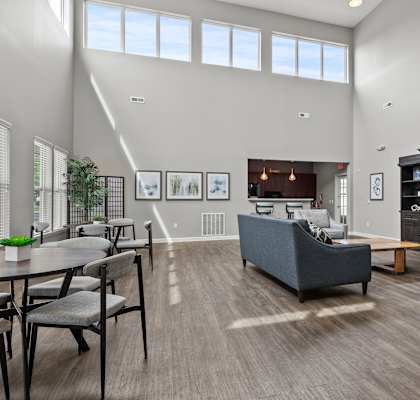 A modern living room with a grey sofa and a wooden cabinet.