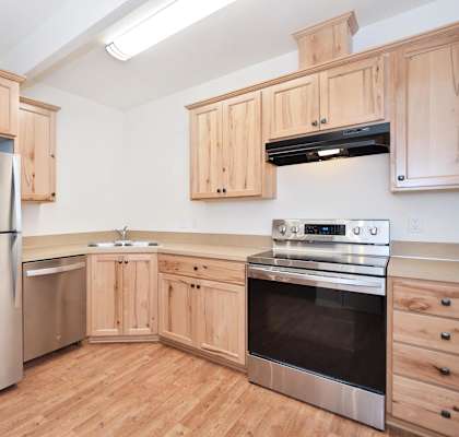 a kitchen with wooden cabinets and stainless steel appliances