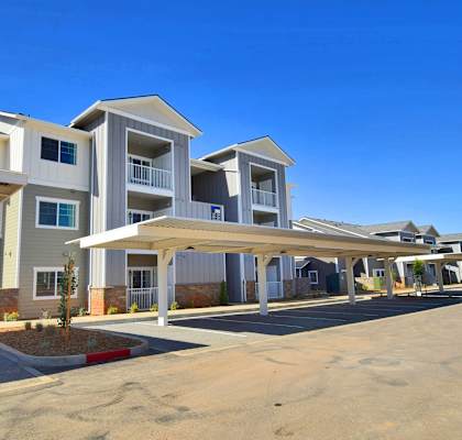 a row of apartment buildings with a blue sky in the background