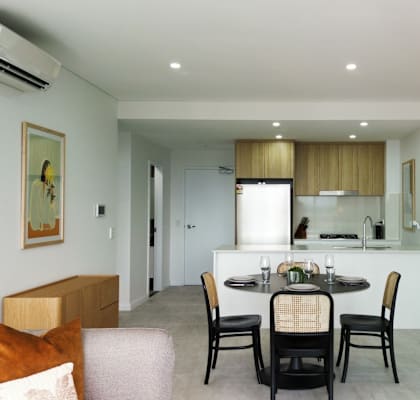 A dining area with a table set for two.