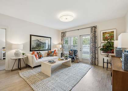 Living room with patio door at The Duke of Charleston apartments in Ladson, SC