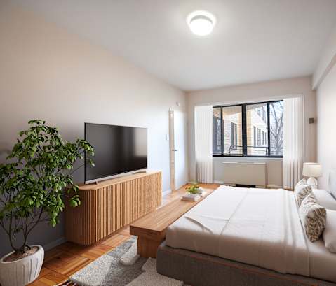 A modern bedroom with a large bed, a television, and a potted plant.
