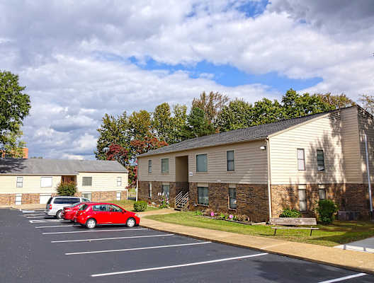 a parking lot at the whispering winds apartments in pearland, tx