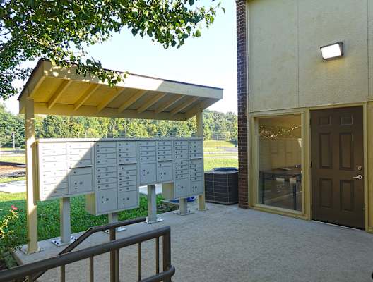 a patio with awning and bench