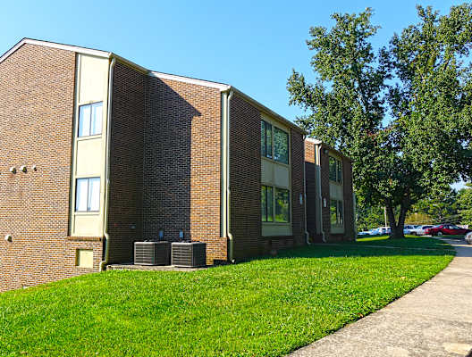a brick building with a grassy area in front of it