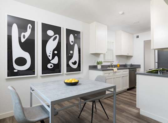 A modern kitchen with a table and chairs in front of a wall with three black and white paintings at Santa Rosa Oaks, Santa Rosa, 95401
