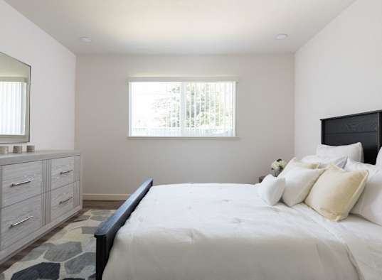 A bedroom with a large bed and a dresser with a mirror at Santa Rosa Oaks, Santa Rosa, 95401