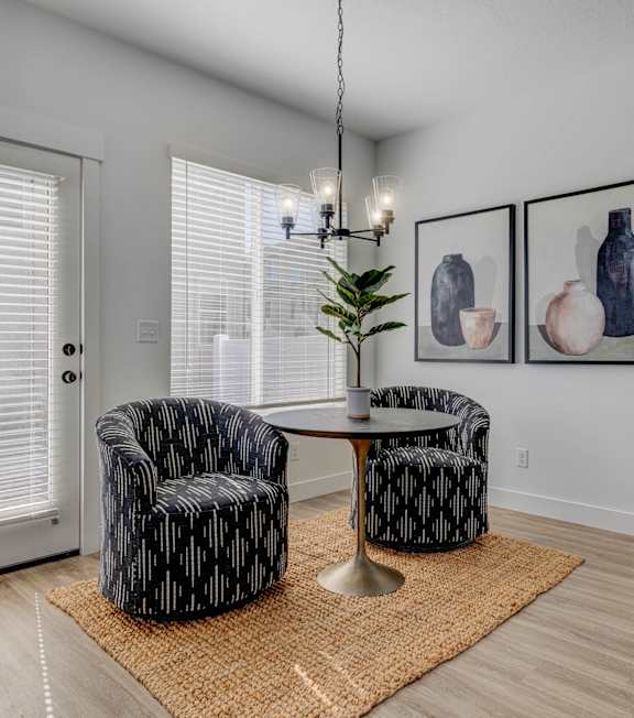 A living room with two chairs and a table.