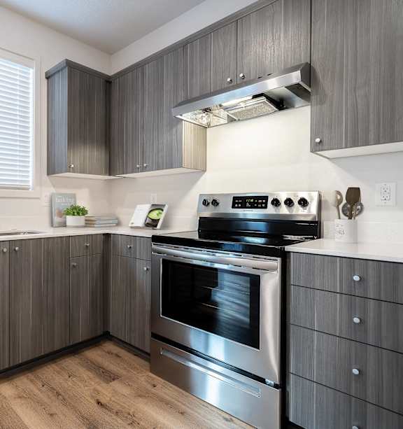 A modern kitchen with stainless steel appliances and wooden cabinets.