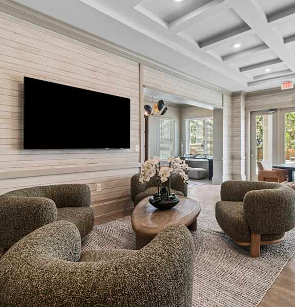 A living room with a large flat screen TV mounted on the wall.