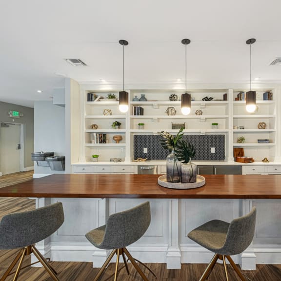 a dining room with a table and chairs in front of a kitchen
