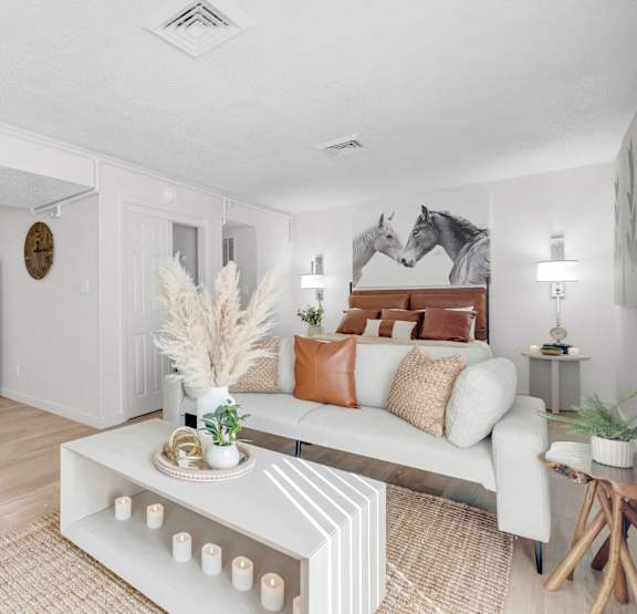 a living room with a couch and a table at AVIA Lofts on Liberty Ridge, Jacksonville, FL