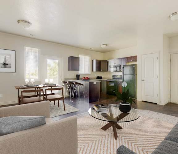 a living room and kitchen with a couch and a table