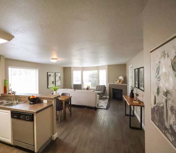A kitchen with white cabinets and a wooden island.