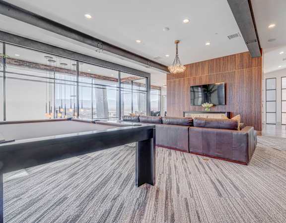 a large living room with a pool table