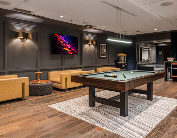 A room with a pool table and a television at Clayton on the Park Apartments, Clayton, Missouri