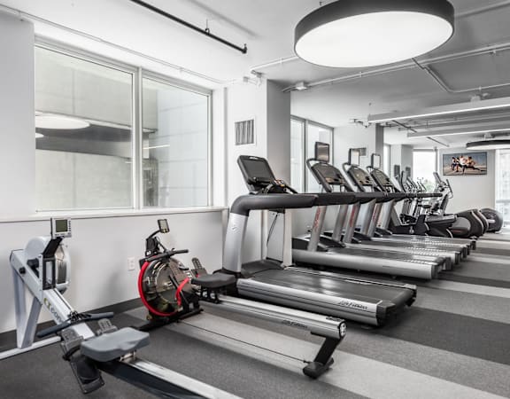 A gym with treadmills and exercise bikes at Clayton on the Park Apartments, Clayton, Missouri