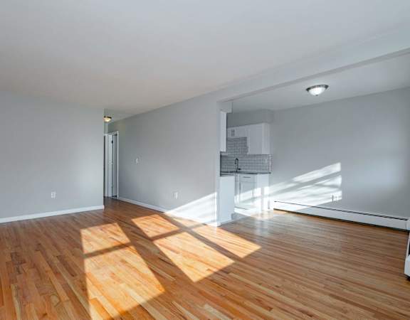 A room with wooden floors and white walls.