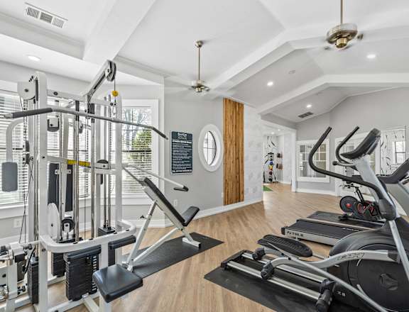 two treadmills and other exercise equipment in a home gym