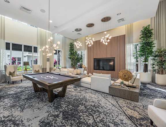 a living room with a pool table in the center