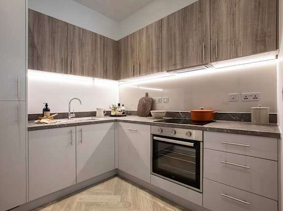 a kitchen with white cabinets and a sink and a stove