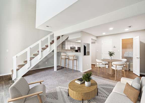 A living room with a fireplace, a couch, and a rug. at Woodcreek Apartments, North Carolina