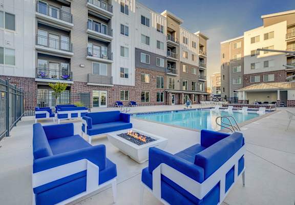 our apartments offer a pool and lounge area with blue furniture