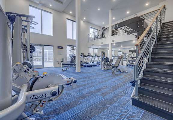 the gym at the flats at obsidian tower has cardio equipment and stairs