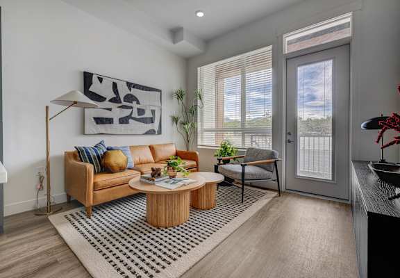 A living room with a brown sofa and a coffee table.