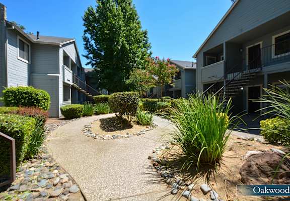 a view of a courtyard between two apartment buildings