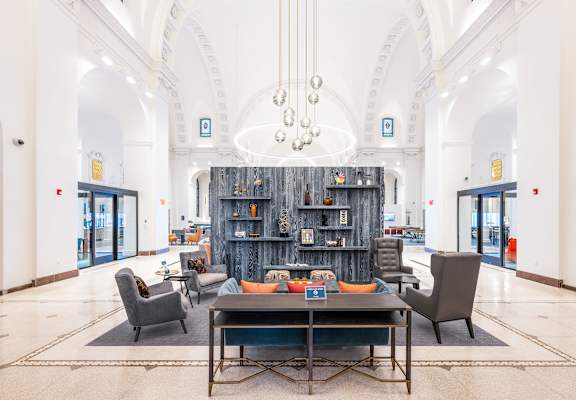 A large room with a long table and chairs and a bookshelf.