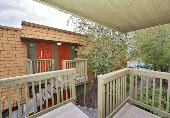 the deck of the home has views of the city and the trees