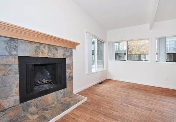 a living room with a fireplace and a wooden floor