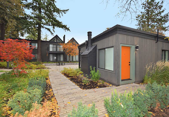 the exterior of a house with an orange door
