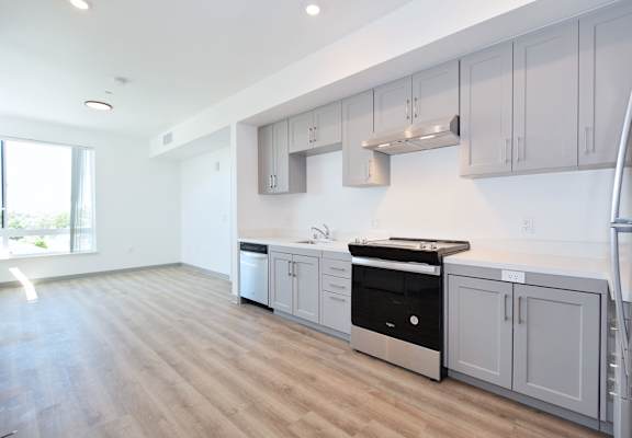 a kitchen with white cabinets and a black stove top oven