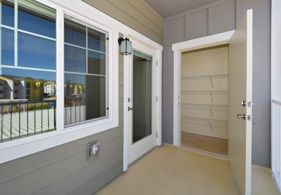 a front porch with a door and windows