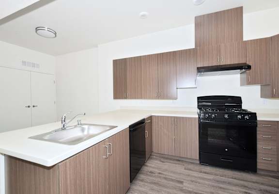 a kitchen with white countertops and wooden cabinets