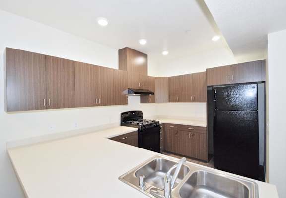 a kitchen with black appliances and white counter tops