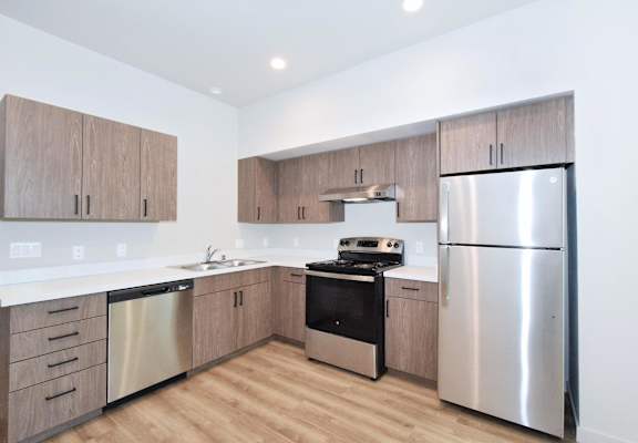 a kitchen with wooden cabinets and stainless steel appliances