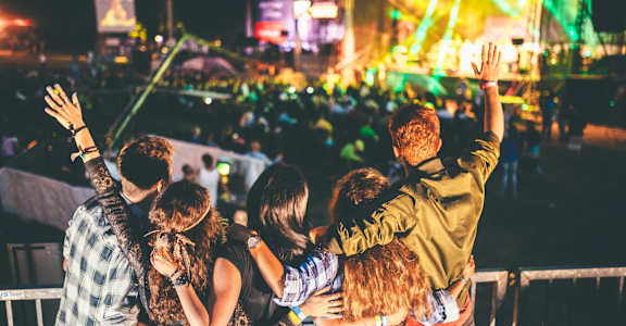 a group of people standing in front of a stage with their hands in the air at Aston at Gateway Apartments, El Monte, California