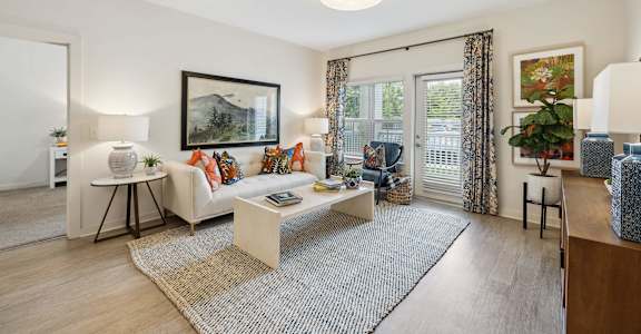 Living room with patio door at The Duke of Charleston apartments in Ladson, SC