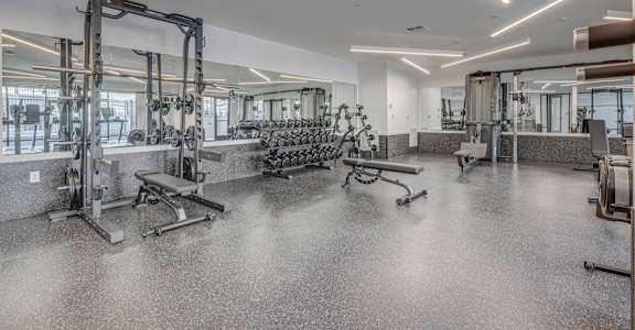 a gym with weights machines and other exercise equipment in a building