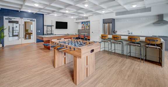 A game table with chairs is in the middle of a room.